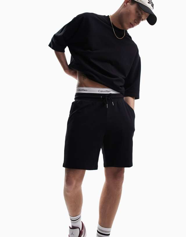 ASOS DESIGN tracksuit with oversized short sleeve sweatshirt & slim shorts in black