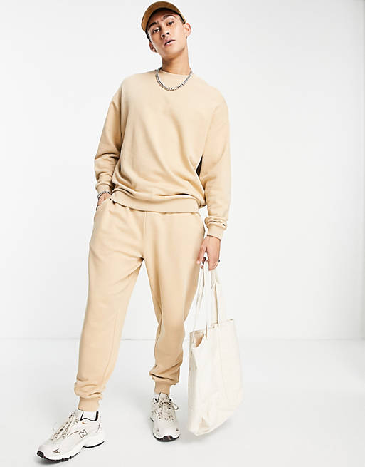 Men tracksuit with oversized sweatshirt and tapered joggers in beige 