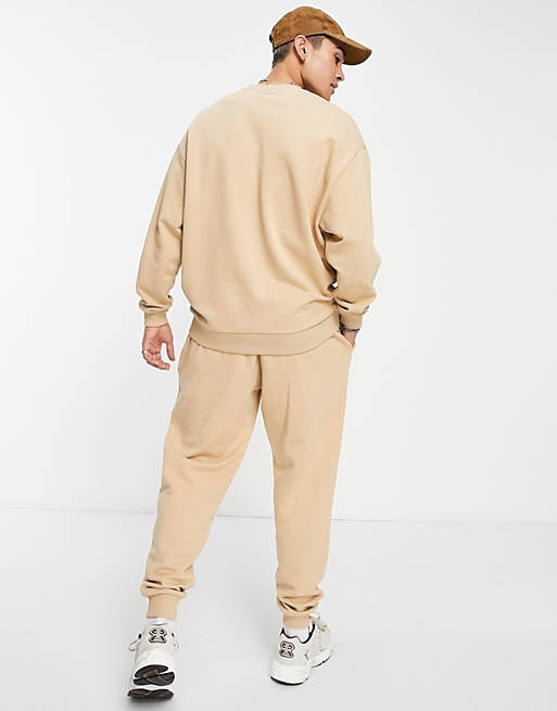 Men tracksuit with oversized sweatshirt and tapered joggers in beige 