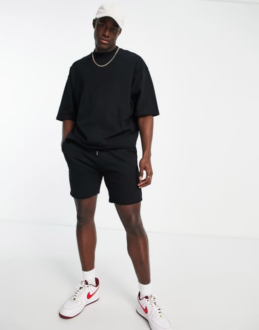 ASOS DESIGN tracksuit with short sleeve sweatshirt and slim shorts in black