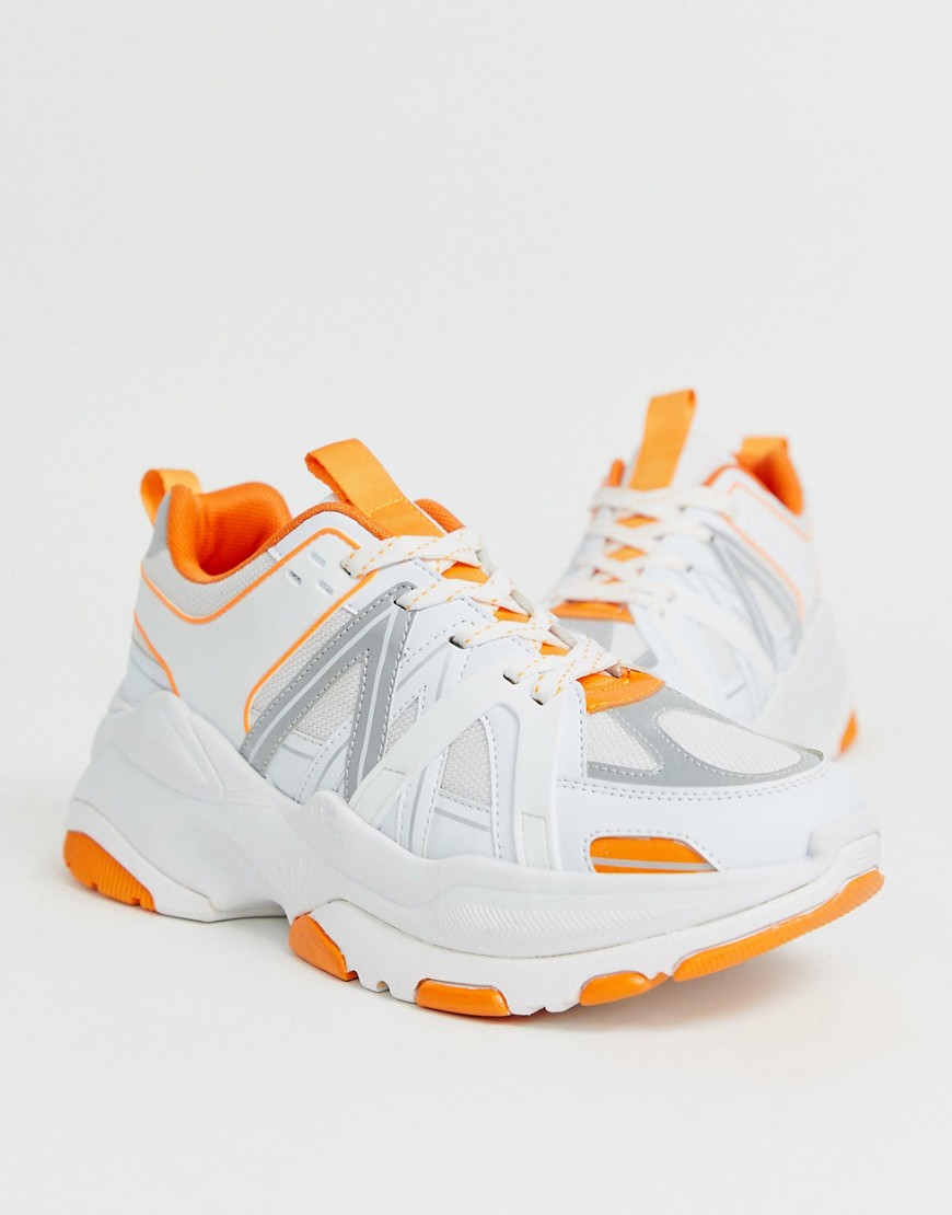 ASOS DESIGN trainers in white with orange colour pop and chunky sole