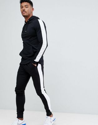 ASOS DESIGN - Trainingspak - Aansluitende hoodie en extreem superskinny joggingbroek met witte zijstreep in zwart