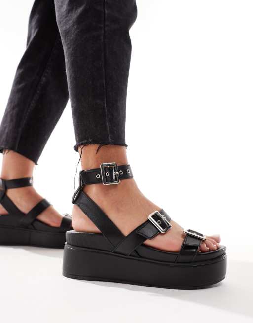 ASOS DESIGN Trombone chunky buckle detail flatforms in black ASOS