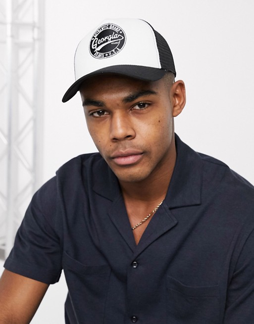 ASOS DESIGN trucker cap in black and white with branded badge