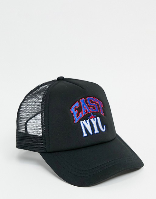 ASOS DESIGN trucker cap in black with badge detail