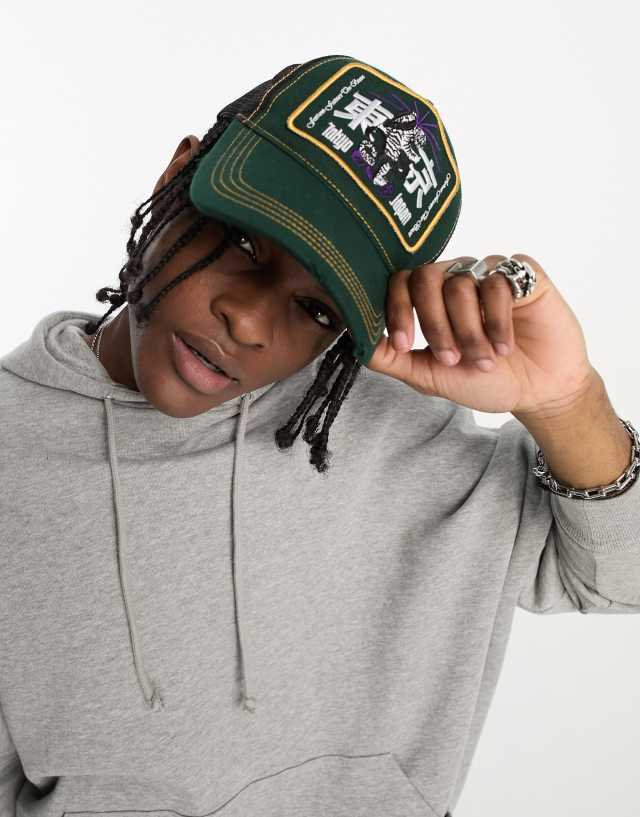 ASOS DESIGN trucker cap with Tokyo badge in green