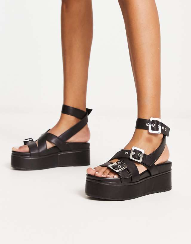 ASOS DESIGN Trumpet chunky buckle detail flatforms in black