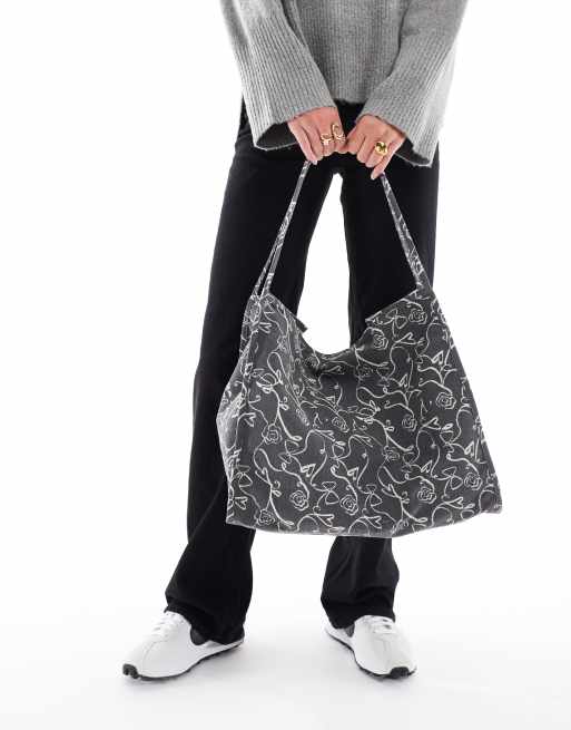 ASOS DESIGN tubular handle canvas tote bag in squiggle bow & heart print