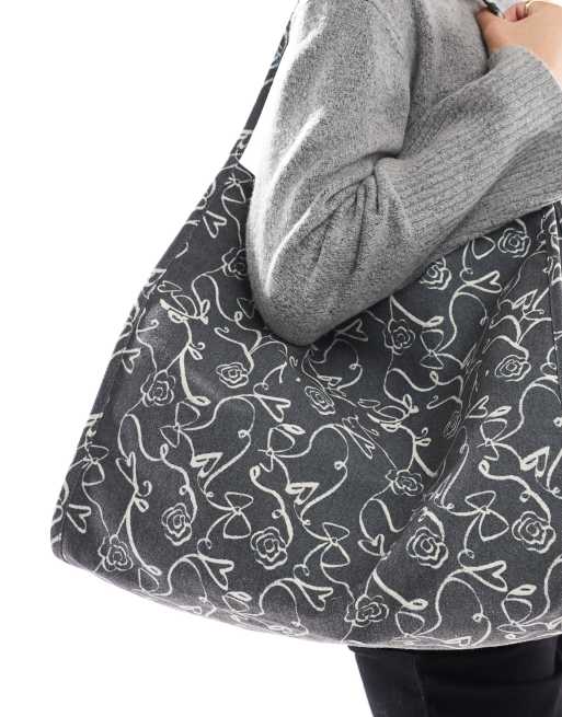 ASOS DESIGN tubular handle canvas tote bag in squiggle bow & heart print