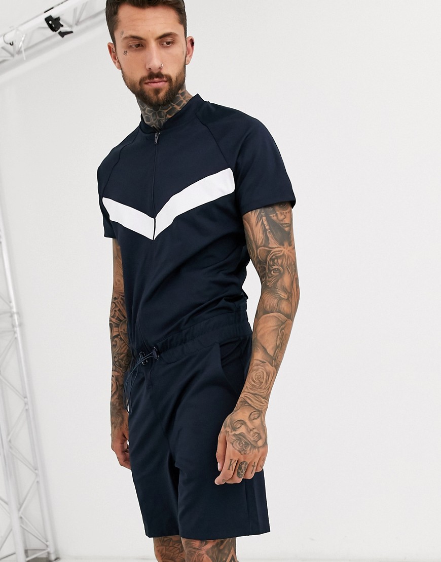 ASOS DESIGN - Tuta jumpsuit corta in tricot di poliestere con motivo a V blu navy