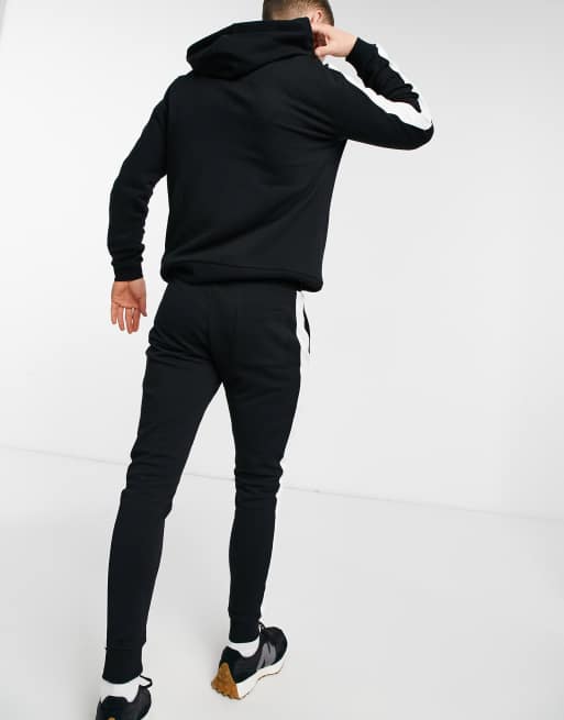 ASOS DESIGN - Tuta sportiva nera con riga laterale, 2 di 4