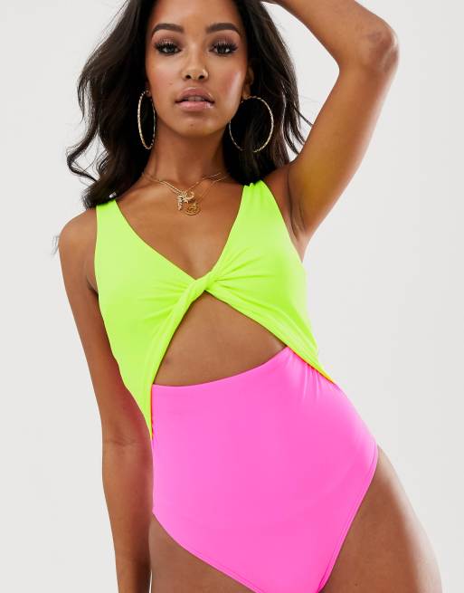 ASOS DESIGN twist front color block swimsuit in neon yellow and pink