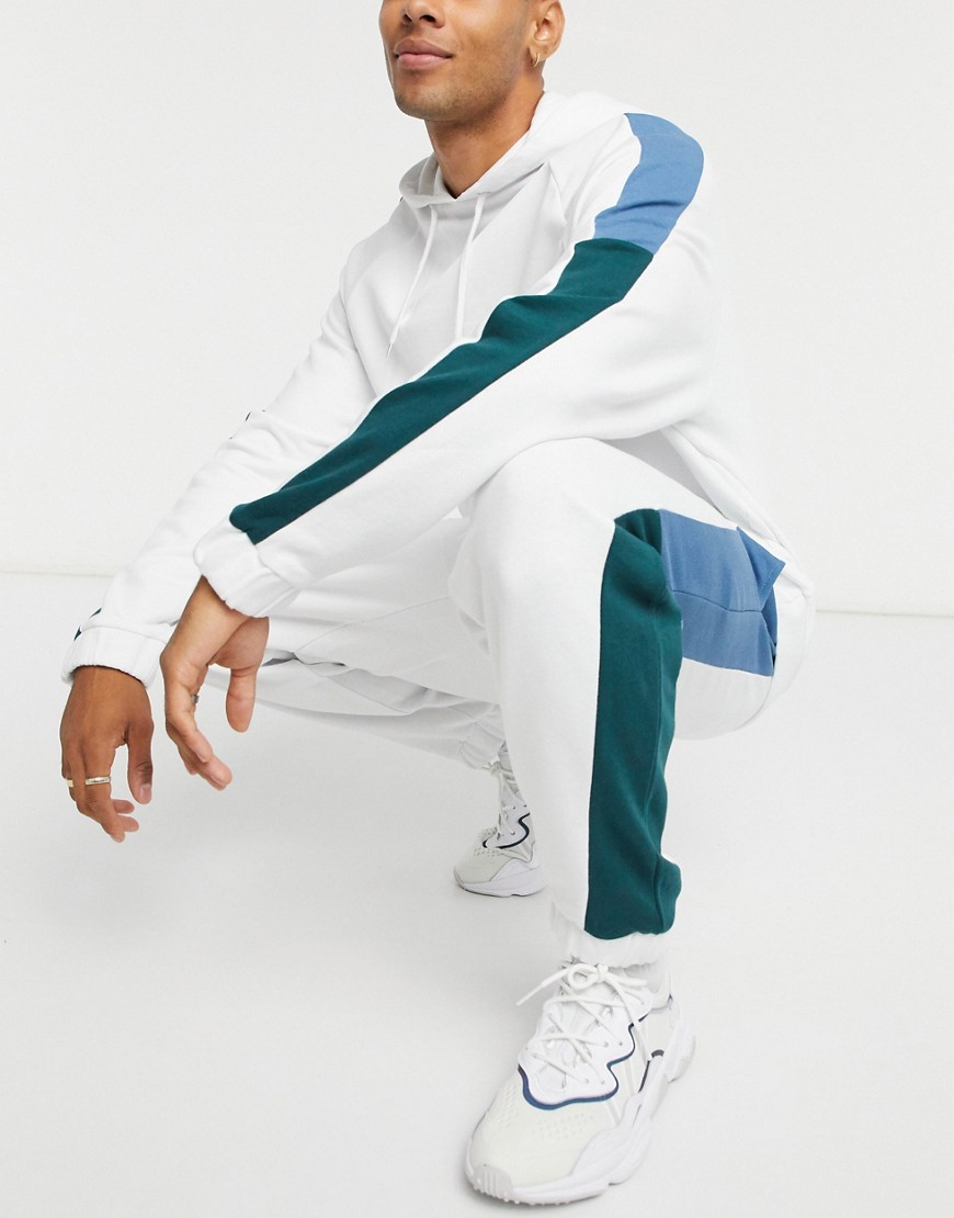 ASOS DESIGN two-piece oversized sweatpants in white with color block side stripes