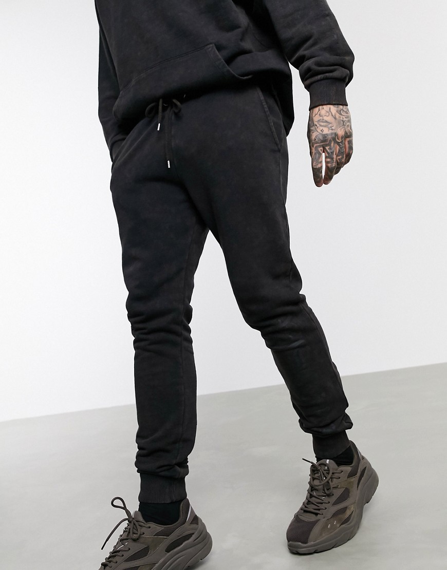 ASOS DESIGN two-piece skinny sweatpants in black acid wash with print