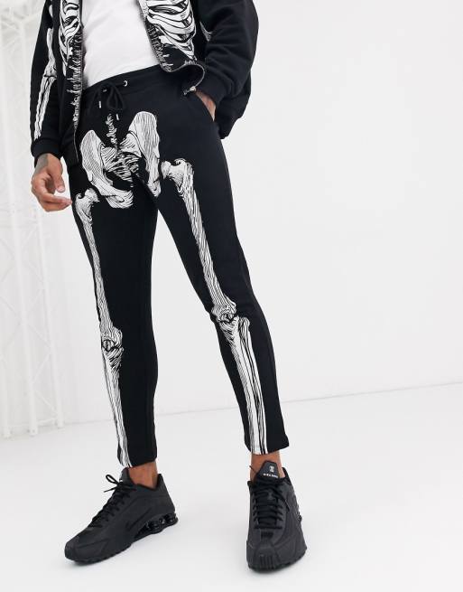 ASOS DESIGN two-piece skinny sweatpants in black with halloween skeleton print | ASOS