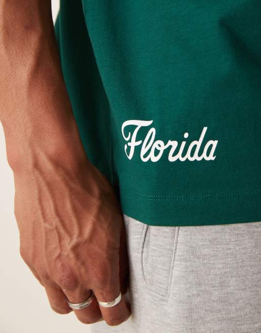 ASOS DESIGN Unisex oversized licensed t-shirt with Florida Gators prints in dark green