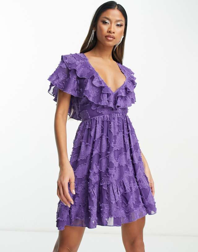 ASOS DESIGN v front v back ruffle mini dress with flutter sleeve and tie belt in textured jacquard in purple