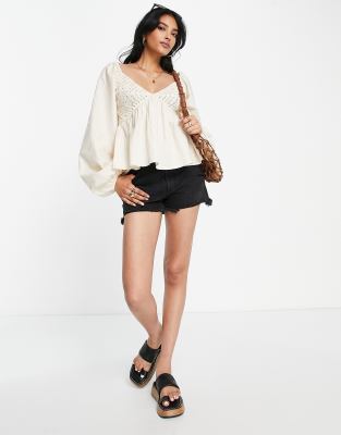 ASOS DESIGN cropped long sleeve crochet top with peplum hem in cream