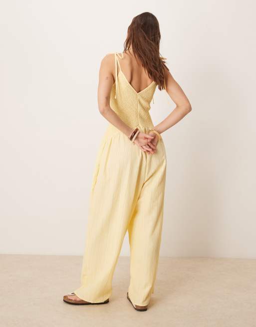 ASOS DESIGN V-neck poly crinkle dropped waist jumpsuit in lemon yellow