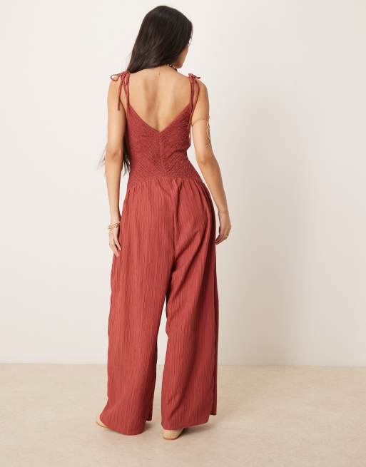 ASOS DESIGN V neck poly crinkle dropped waist jumpsuit in rust
