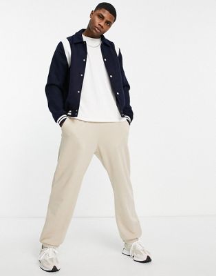 ASOS DESIGN varsity bomber jacket in navy with contrast white inserts