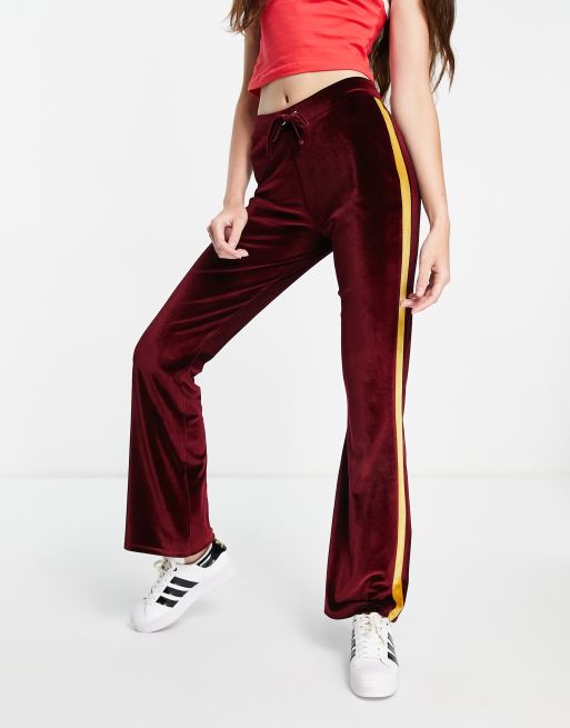 ASOS DESIGN velour flare pants with varsity side stripe in burgundy