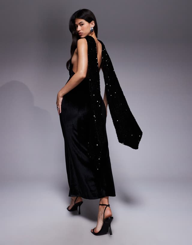 asos black sequin maxi dress DESIGN velvet with scarf detail and open back in Embellished sequin Size:11M color:sevila-mini-dress-crinkle-black-1 swatch:https://www.motelrocks.com/cdn/shop/files/SEVILA-MINI-DRESS-CRINKLE-BLACK_7869D.jpg?v=1704261427&width=100 Flirty Black Dress - Crafted from a comfortable