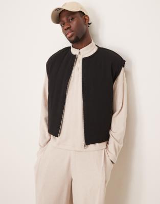 ASOS DESIGN - Veste sans manches courte et oversize en tissu rembourré épais - Noir