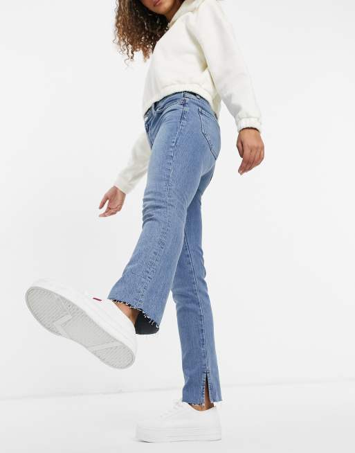 ASOS DESIGN - Vintage skinny jeans met halfhoge taille in midwash met split in de zoom
