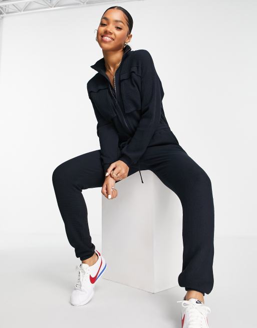 ASOS DESIGN waffle slouchy jogger jumpsuit with pockets in navy ASOS