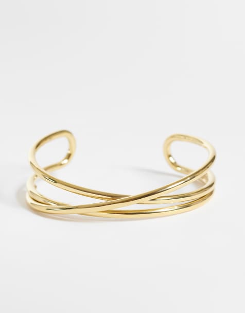 ASOS DESIGN waterproof stainless steel cuff bracelet with cross-over design in gold tone - view 1