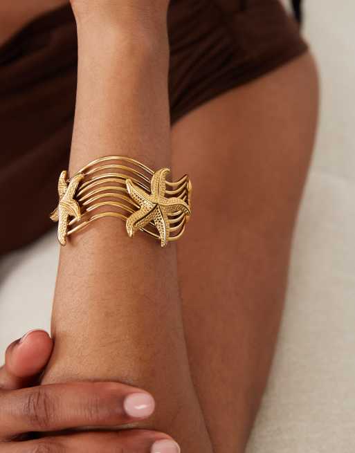 ASOS DESIGN waterproof stainless steel cuff with starfish design in gold tone, 2 of 4