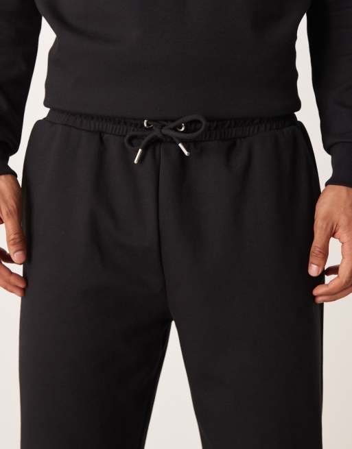ASOS DESIGN – Weiche, schmal zulaufende Jogginghose in Schwarz, Kombiteil, 5 von 5