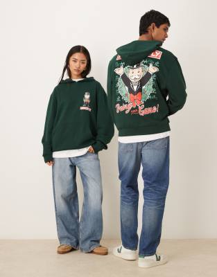 ASOS DESIGN - Weihnachten - Relaxed-Fit-Kapuzenpullover in Grün mit „Monopoly"-Prints