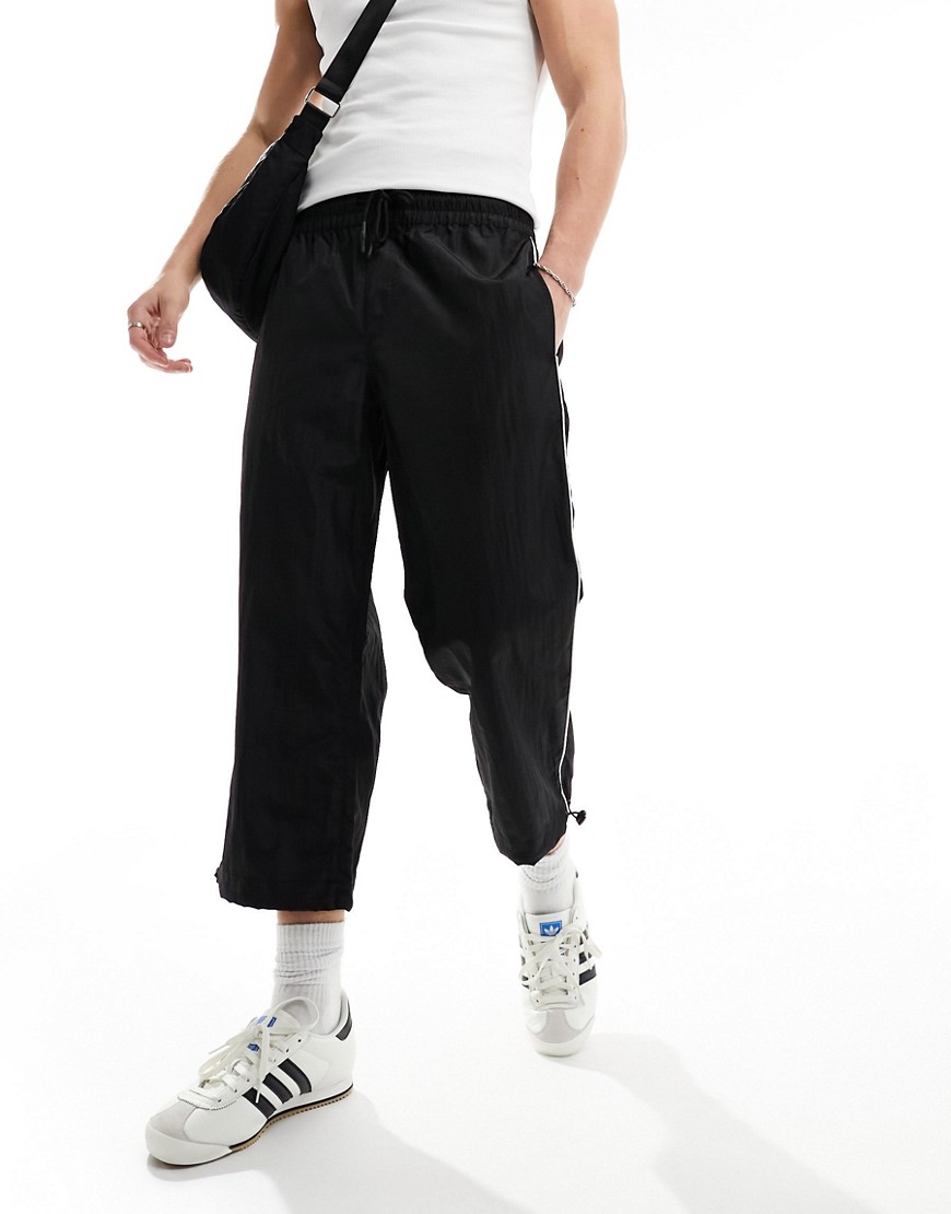 ASOS DESIGN wide awkward length nylon trouser with toggle detail in black
