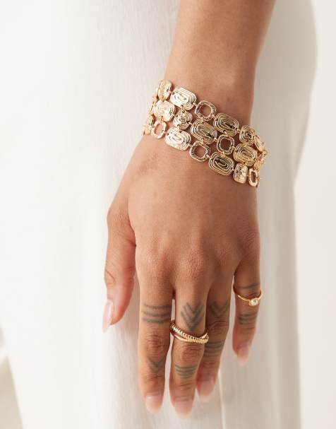ASOS DESIGN wide bracelet with swirly design in gold tone - view 1