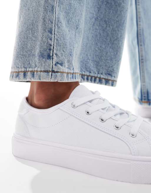 ASOS DESIGN lace-up sneakers in white with embossed monogram