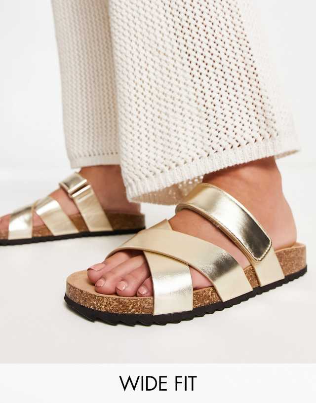 ASOS DESIGN Wide Fit Fiery cross strap flat sandals in gold