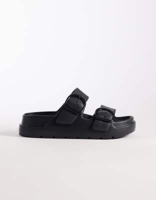 ASOS DESIGN Wide Fit - Finn - Slider in Schwarz mit flacher Plateausohle und zwei Schnallen, weite Passform