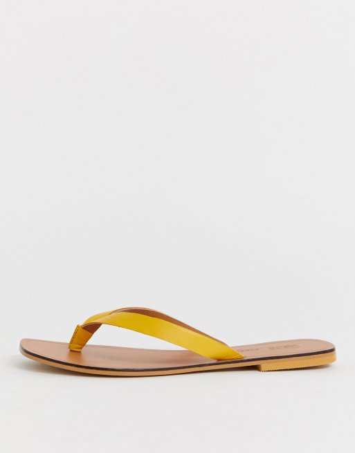 ASOS DESIGN Wide Fit Florence leather flip flop sandals in yellow