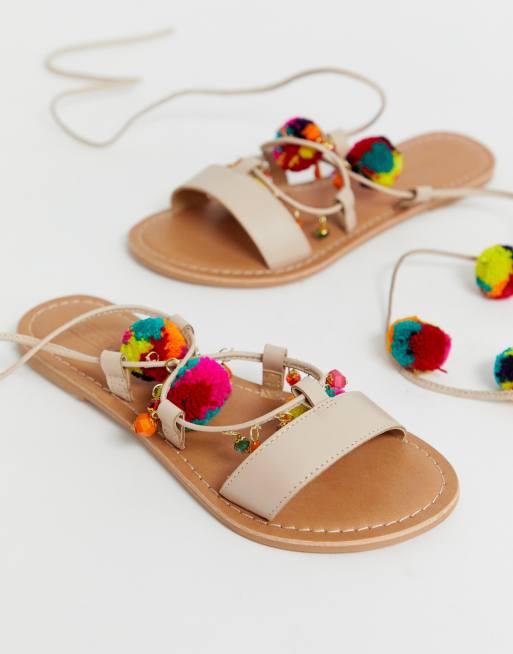 DESIGN Wide Fit Fun pom pom leather tie leg flat sandals | ASOS