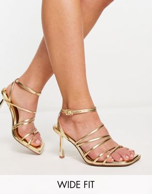 ASOS DESIGN Wide Fit Hamper strappy mid heeled sandals in gold - ASOS Price Checker