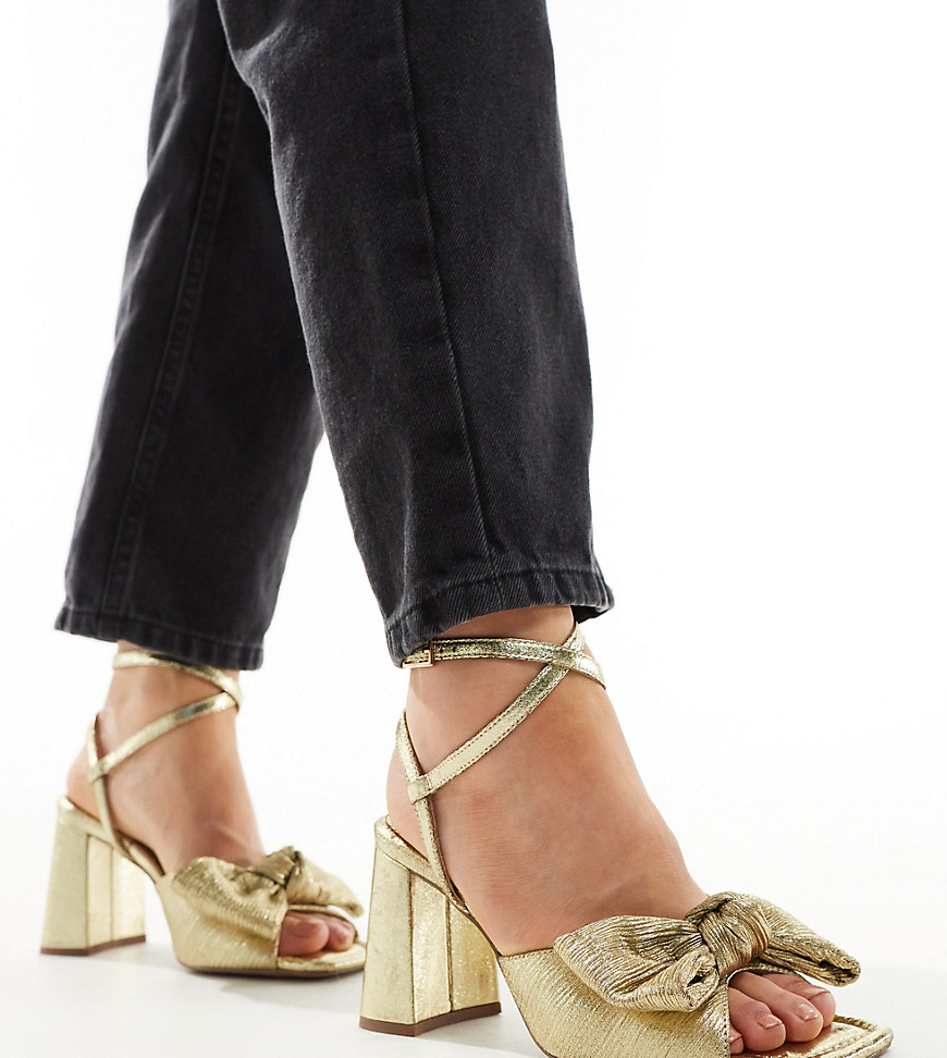 ASOS DESIGN Wide Fit Hitched bow detail mid block heeled sandals in gold
