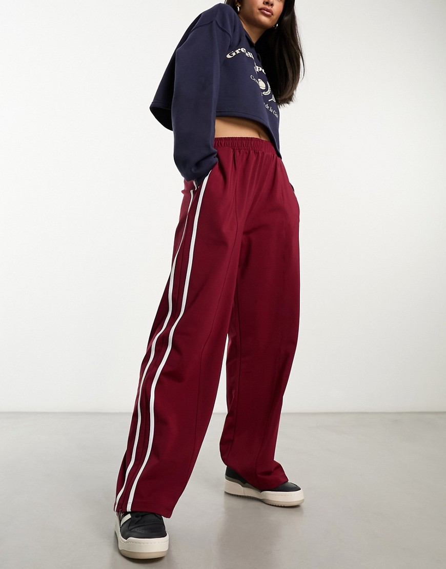 ASOS DESIGN wide leg jogger with side stripe in burgundy-Red
