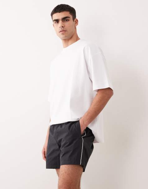 ASOS DESIGN wide mid length elasticated nylon short with piping styling in black - view 1