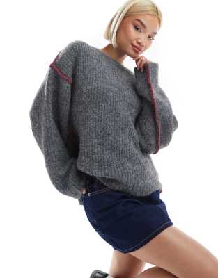 wool blend knit sweater with red blanket stitch seams in gray