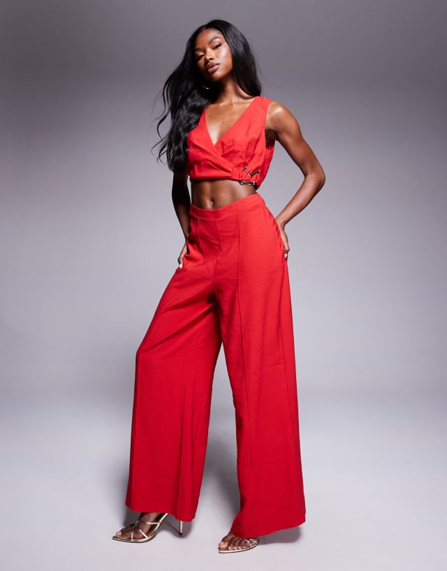 ASOS DESIGN wrap front cut out jumpsuit with buckle detail in red