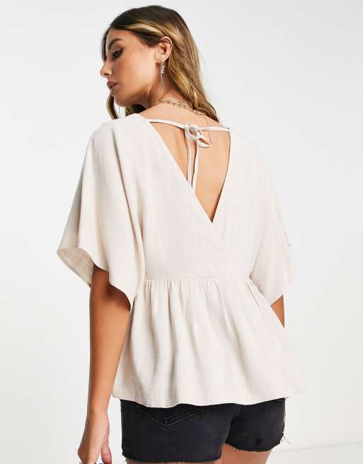 ASOS DESIGN wrap top with angel sleeve & peplum hem in natural | ASOS