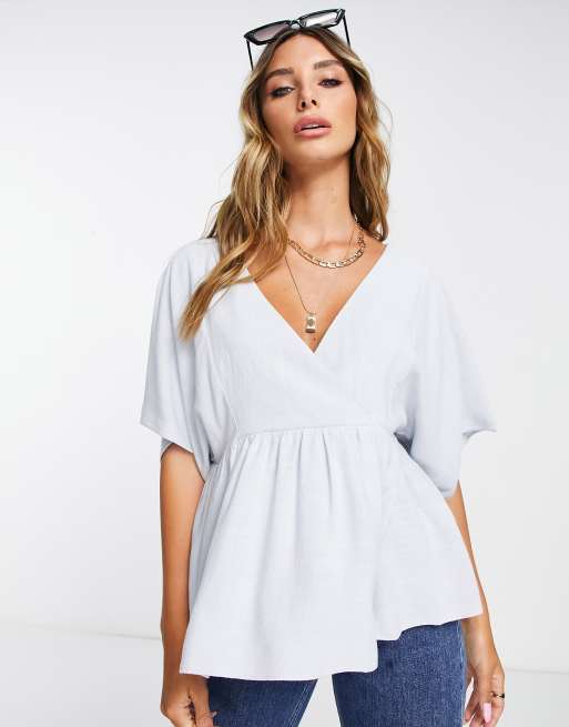 ASOS DESIGN wrap top with angel sleeves & peplum hem in icy blue