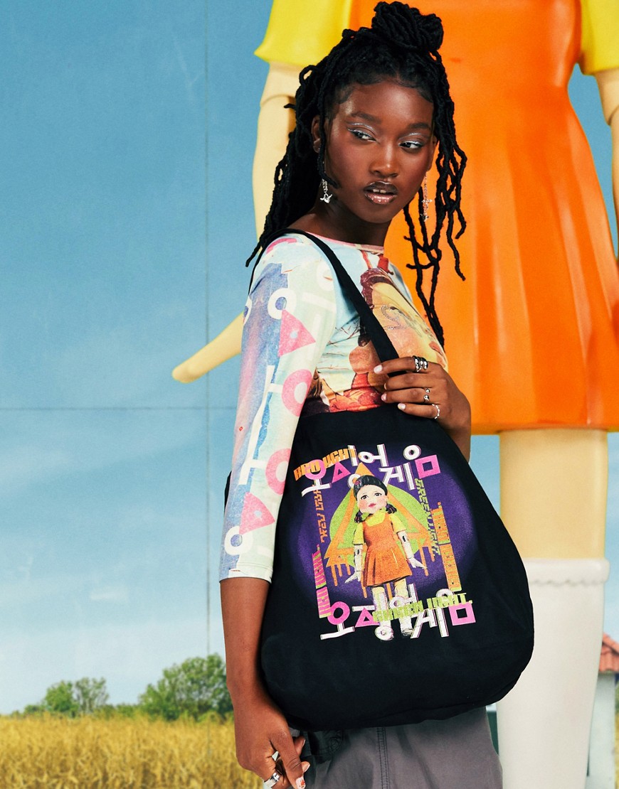 ASOS DESIGN X Squid Game: The Challenge black tote back with Younghee Doll print-Multi